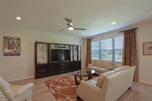 5908 Paxton Ct, Apopka, FL 32703 - living room with light wood finished floors, ceiling fan, baseboards, recessed lighting, and a textured ceiling