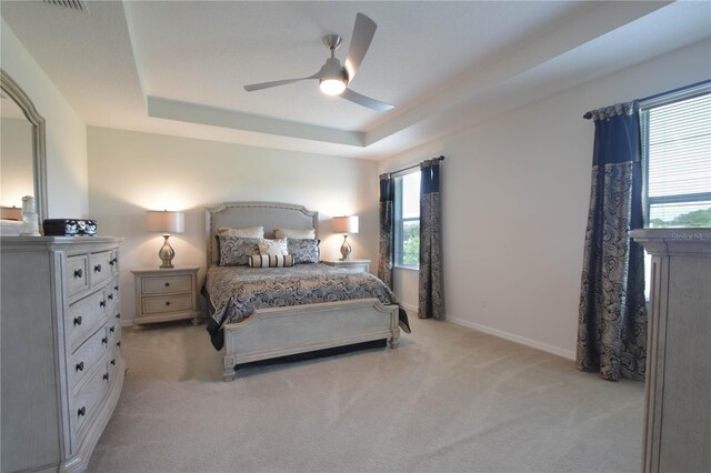 5908 Paxton Ct, Apopka, FL 32703 - bedroom featuring a raised ceiling, light colored carpet, a ceiling fan, and baseboards