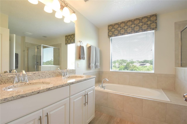 5908 Paxton Ct, Apopka, FL 32703 - bathroom featuring a stall shower, a garden tub, double vanity, and wood finished floors