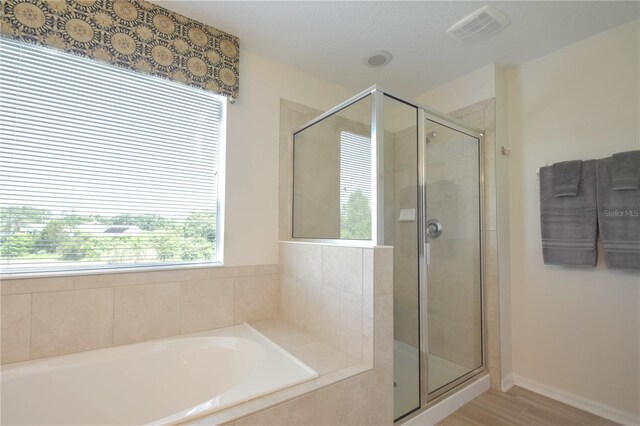 5908 Paxton Ct, Apopka, FL 32703 - bathroom featuring a garden tub, a stall shower, and wood finished floors