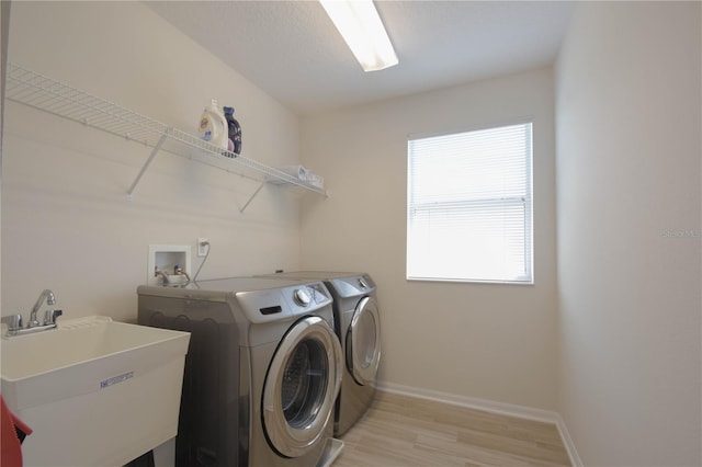 5908 Paxton Ct, Apopka, FL 32703 - laundry area with independent washer and dryer, light wood-style flooring, and baseboards
