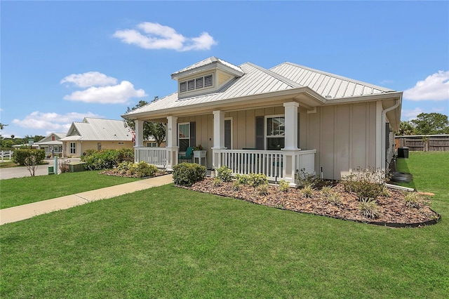 106 Turtle Run, Umatilla, FL 32784 - view of front facade featuring board and batten siding, covered porch, metal roof, and central AC