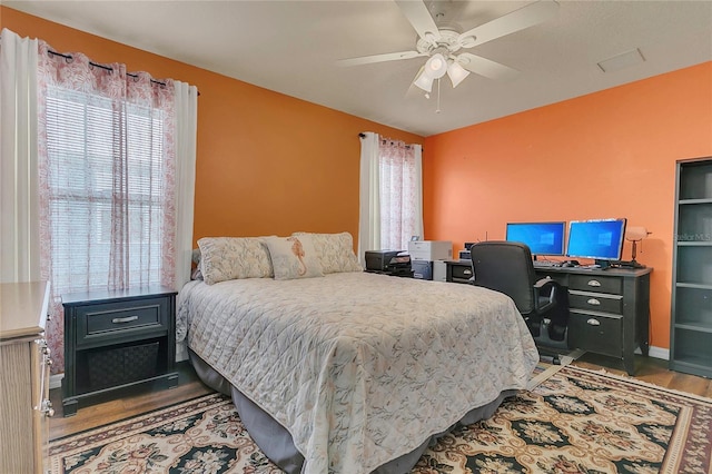 106 Turtle Run, Umatilla, FL 32784 - bedroom featuring wood finished floors, a desk, and a ceiling fan