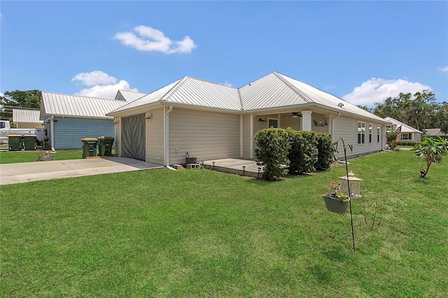 106 Turtle Run, Umatilla, FL 32784 - view of side of property featuring concrete driveway, an attached garage, a lawn, a ceiling fan, and metal roof