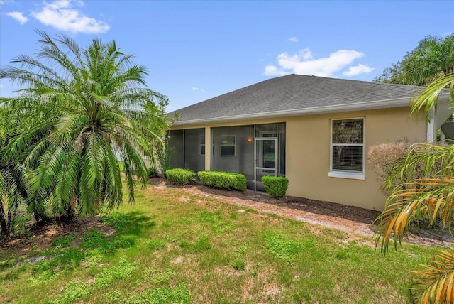 3304 Bennington Ct, Winter Park, FL 32792 - back of property featuring a sunroom, stucco siding, a yard, and roof with shingles