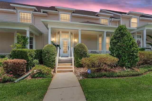 152 Riggings Way, Clermont, FL 34711 - exterior entry at dusk with covered porch and a shingled roof