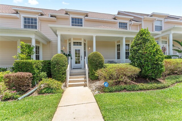 152 Riggings Way, Clermont, FL 34711 - doorway to property with covered porch and a shingled roof