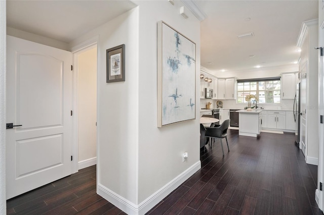 152 Riggings Way, Clermont, FL 34711 - hall featuring dark wood-type flooring, baseboards, and a sink