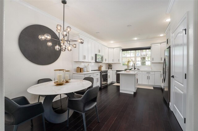 152 Riggings Way, Clermont, FL 34711 - dining space with crown molding, dark wood-type flooring, a chandelier, and recessed lighting