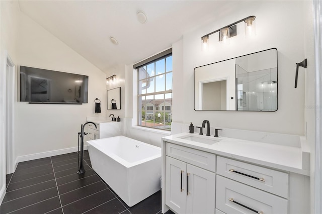 152 Riggings Way, Clermont, FL 34711 - full bathroom featuring a freestanding bath, vanity, vaulted ceiling, tile patterned floors, and baseboards