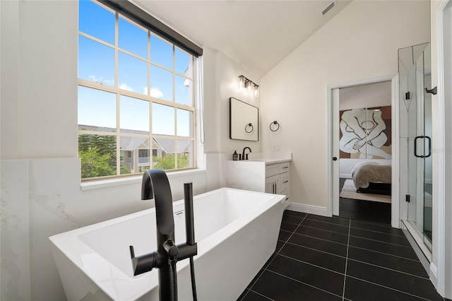 152 Riggings Way, Clermont, FL 34711 - bathroom featuring vanity, a freestanding tub, lofted ceiling, tile patterned flooring, and ensuite bathroom