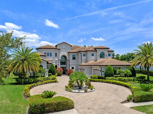4071 Isabella Cir, Windermere, FL 34786 - mediterranean / spanish home with curved driveway, stucco siding, a front lawn, and a tile roof