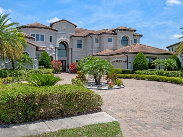 4071 Isabella Cir, Windermere, FL 34786 - mediterranean / spanish home with curved driveway, stucco siding, a tile roof, and an attached garage