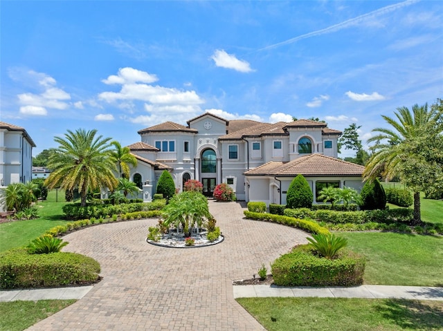 4071 Isabella Cir, Windermere, FL 34786 - mediterranean / spanish-style house featuring curved driveway, french doors, a front lawn, and stucco siding