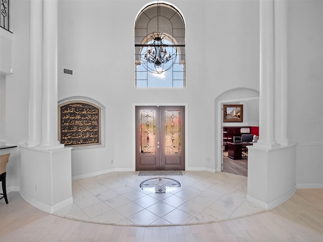 4071 Isabella Cir, Windermere, FL 34786 - entrance foyer with decorative columns, a chandelier, french doors, baseboards, and a high ceiling