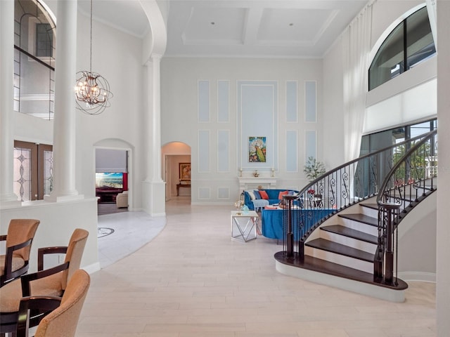 4071 Isabella Cir, Windermere, FL 34786 - foyer featuring decorative columns, a high ceiling, arched walkways, coffered ceiling, and a chandelier