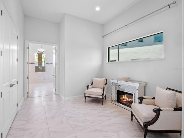 4071 Isabella Cir, Windermere, FL 34786 - living area with a tile fireplace, light marble finish flooring, a chandelier, recessed lighting, and baseboards