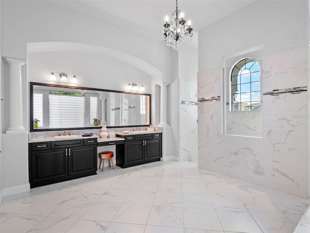 4071 Isabella Cir, Windermere, FL 34786 - bathroom featuring decorative columns, marble look tiles, vanity, and a marble finish shower