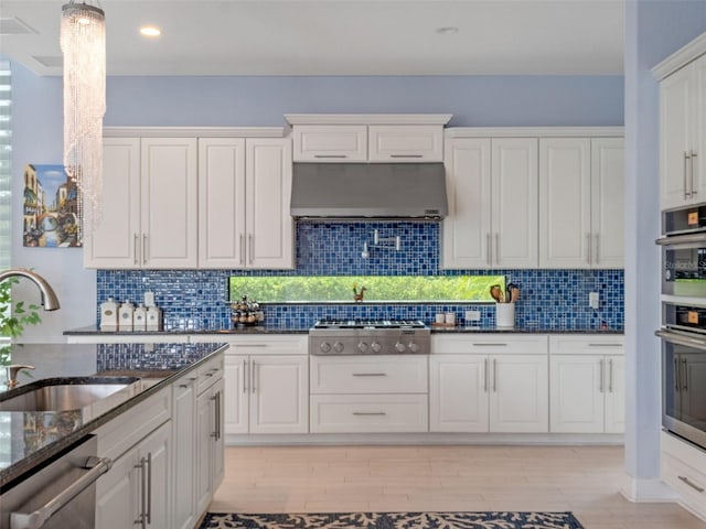 4071 Isabella Cir, Windermere, FL 34786 - kitchen with under cabinet range hood, a sink, appliances with stainless steel finishes, white cabinetry, and recessed lighting