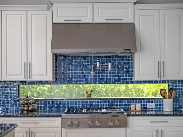 4071 Isabella Cir, Windermere, FL 34786 - kitchen with exhaust hood, stainless steel gas stovetop, white cabinets, and decorative backsplash