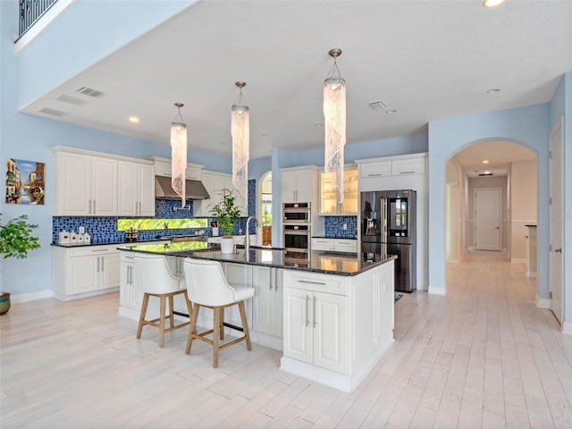 4071 Isabella Cir, Windermere, FL 34786 - kitchen with stainless steel appliances, arched walkways, backsplash, a sink, and recessed lighting