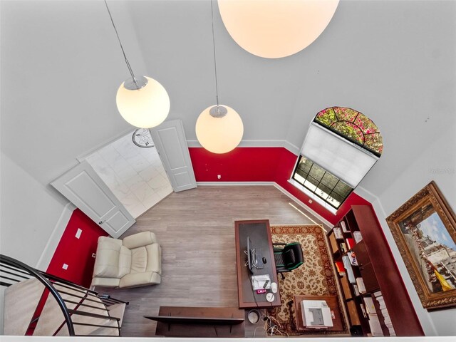 4071 Isabella Cir, Windermere, FL 34786 - living area featuring a towering ceiling, wood finished floors, and baseboards