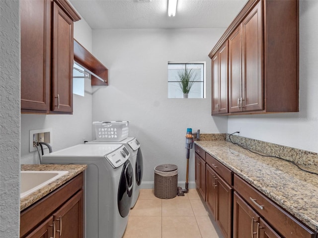 4071 Isabella Cir, Windermere, FL 34786 - laundry room with cabinet space, washer and clothes dryer, light tile patterned flooring, baseboards, and a textured ceiling