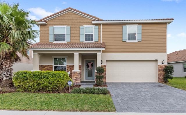 1640 Oak Blossom Dr, Davenport, FL 33837 - view of front of property with a tile roof, decorative driveway, stucco siding, and a garage