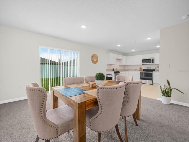 440 Patricia Alford Dr, Haines City, FL 33844 - dining space with light carpet, baseboards, and recessed lighting