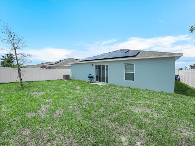 440 Patricia Alford Dr, Haines City, FL 33844 - rear view of property with stucco siding, roof mounted solar panels, and central air condition unit