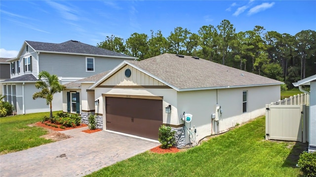 2836 Sanctuary Dr, Clermont, FL 34714 - view of front of home featuring roof with shingles, a garage, driveway, and stone siding