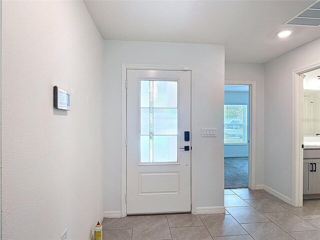 2836 Sanctuary Dr, Clermont, FL 34714 - entryway featuring light tile patterned floors and baseboards