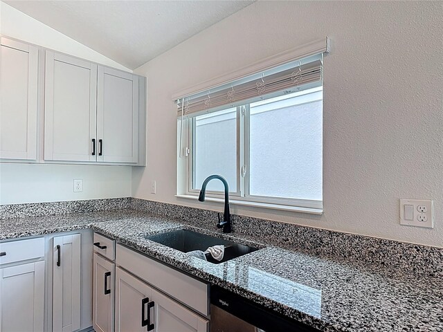 2836 Sanctuary Dr, Clermont, FL 34714 - kitchen featuring a sink, vaulted ceiling, dishwasher, and dark stone counters