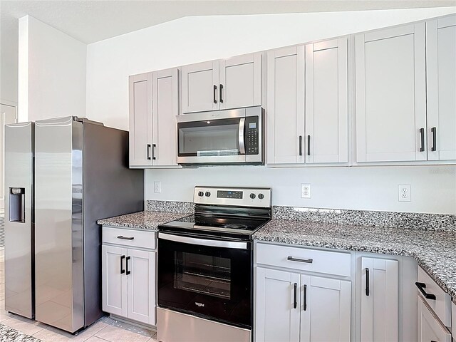 2836 Sanctuary Dr, Clermont, FL 34714 - kitchen featuring stainless steel appliances, light stone counters, and light tile patterned flooring