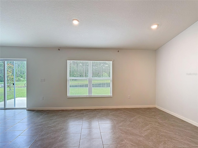 2836 Sanctuary Dr, Clermont, FL 34714 - spare room featuring a textured ceiling, baseboards, recessed lighting, and tile patterned flooring