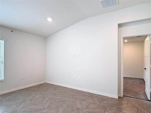2836 Sanctuary Dr, Clermont, FL 34714 - empty room featuring vaulted ceiling, baseboards, a textured ceiling, and recessed lighting