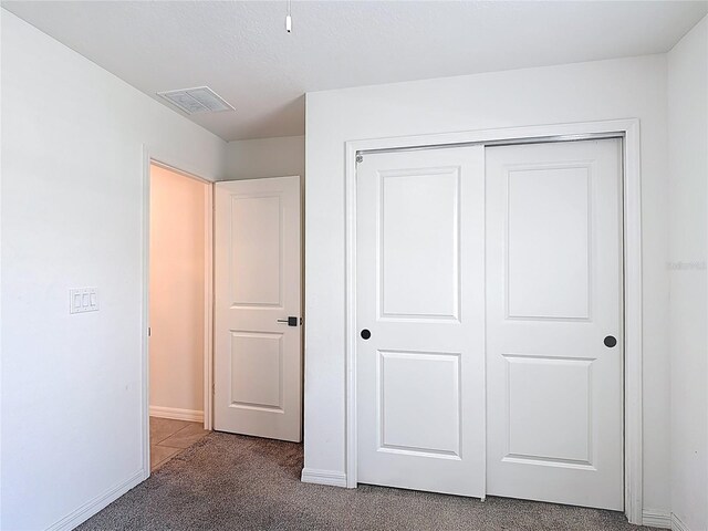 2836 Sanctuary Dr, Clermont, FL 34714 - unfurnished bedroom featuring carpet, baseboards, and a closet