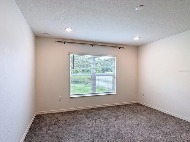 2836 Sanctuary Dr, Clermont, FL 34714 - unfurnished room with carpet floors, a textured ceiling, a smoke detector, baseboards, and recessed lighting