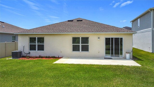 2836 Sanctuary Dr, Clermont, FL 34714 - back of property with a shingled roof, stucco siding, a patio area, and cooling unit