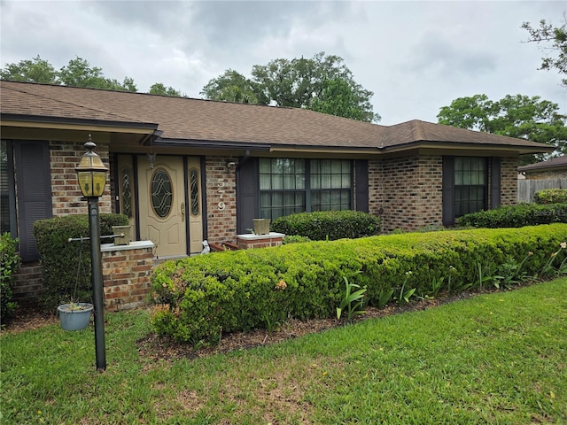 579 Rockingham Rd, Orange Park, FL 32073 - ranch-style home featuring brick siding, a front lawn, and a shingled roof