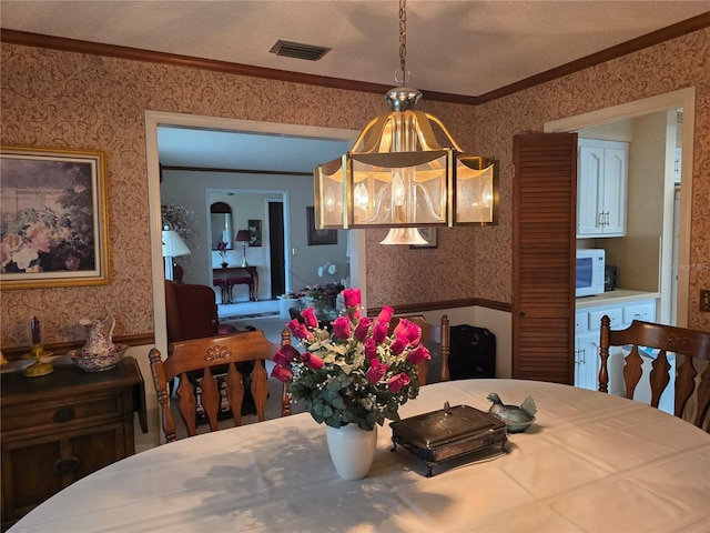 579 Rockingham Rd, Orange Park, FL 32073 - dining area with wallpapered walls and ornamental molding