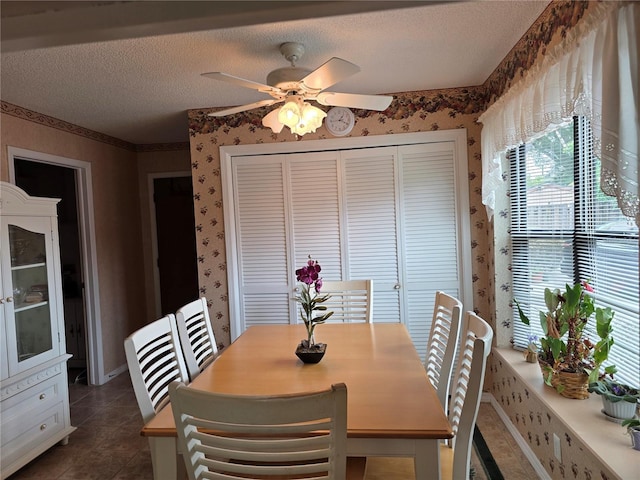 579 Rockingham Rd, Orange Park, FL 32073 - dining room with wallpapered walls, a textured ceiling, plenty of natural light, a ceiling fan, and dark tile patterned floors