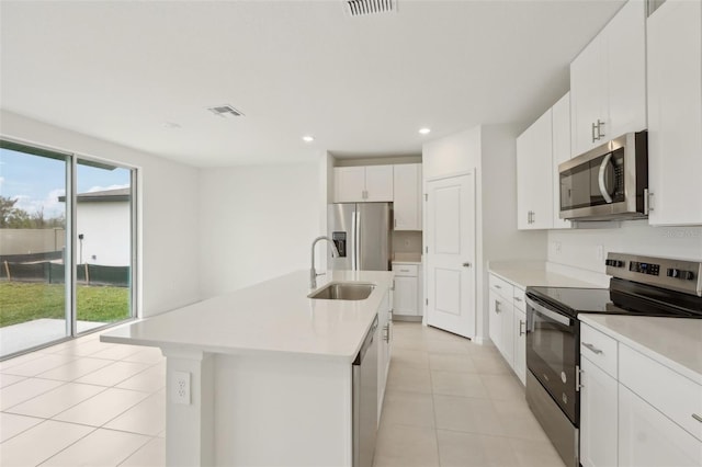 1855 Brekey Way, Zephyrhills, FL 33541 - kitchen with appliances with stainless steel finishes, light tile patterned floors, light countertops, white cabinets, and recessed lighting