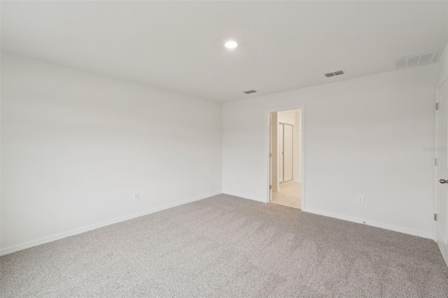 1855 Brekey Way, Zephyrhills, FL 33541 - empty room with light carpet and recessed lighting