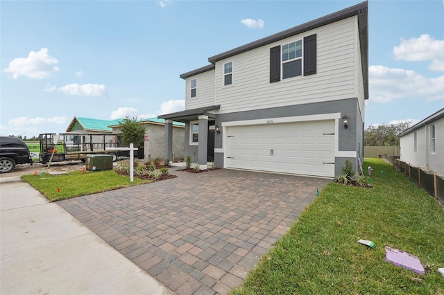 1855 Brekey Way, Zephyrhills, FL 33541 - view of front of home with a garage, decorative driveway, and stucco siding
