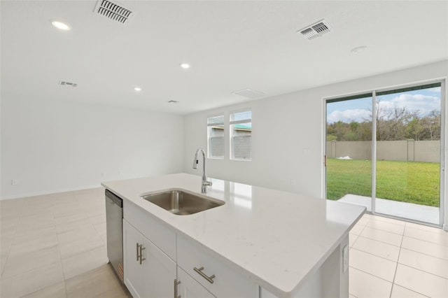 1855 Brekey Way, Zephyrhills, FL 33541 - kitchen featuring dishwasher, healthy amount of natural light, white cabinets, recessed lighting, and a kitchen island with sink