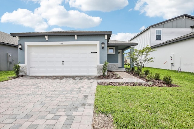 1828 Brekey Way, Zephyrhills, FL 33541 - view of front of house featuring stone siding, decorative driveway, a front yard, stucco siding, and a garage