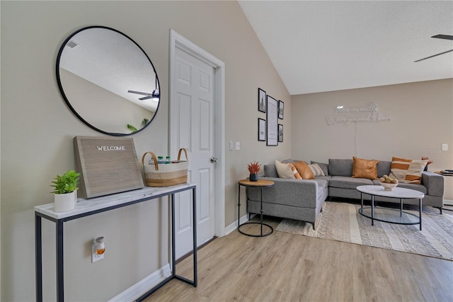 2406 Placid Way, Kissimmee, FL 34758 - living area with light wood-style floors, lofted ceiling, a ceiling fan, and baseboards