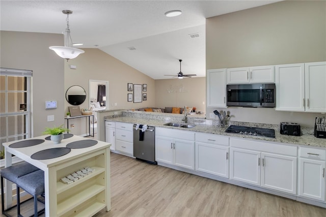 2406 Placid Way, Kissimmee, FL 34758 - kitchen with stainless steel appliances, a sink, white cabinets, vaulted ceiling, and a ceiling fan