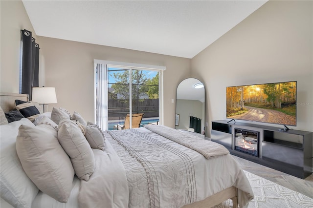 2406 Placid Way, Kissimmee, FL 34758 - bedroom with access to exterior, lofted ceiling, and a glass covered fireplace